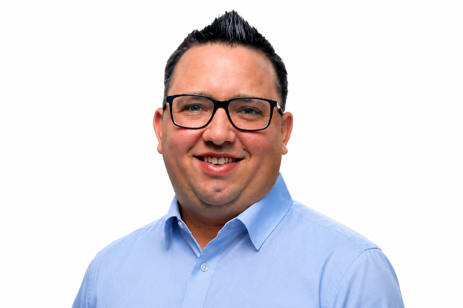 Cody Saunders, smiling, wearing glasses and a light blue shirt